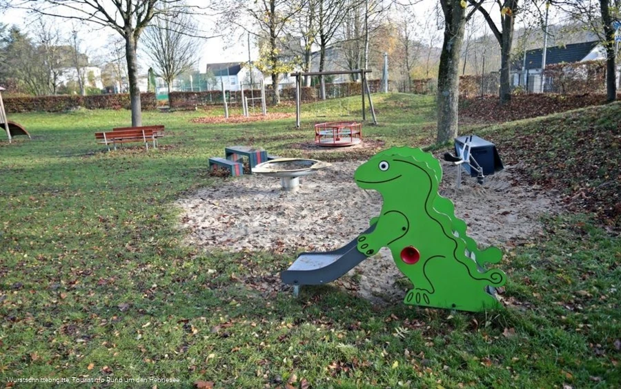 Sandkasten mit Dino